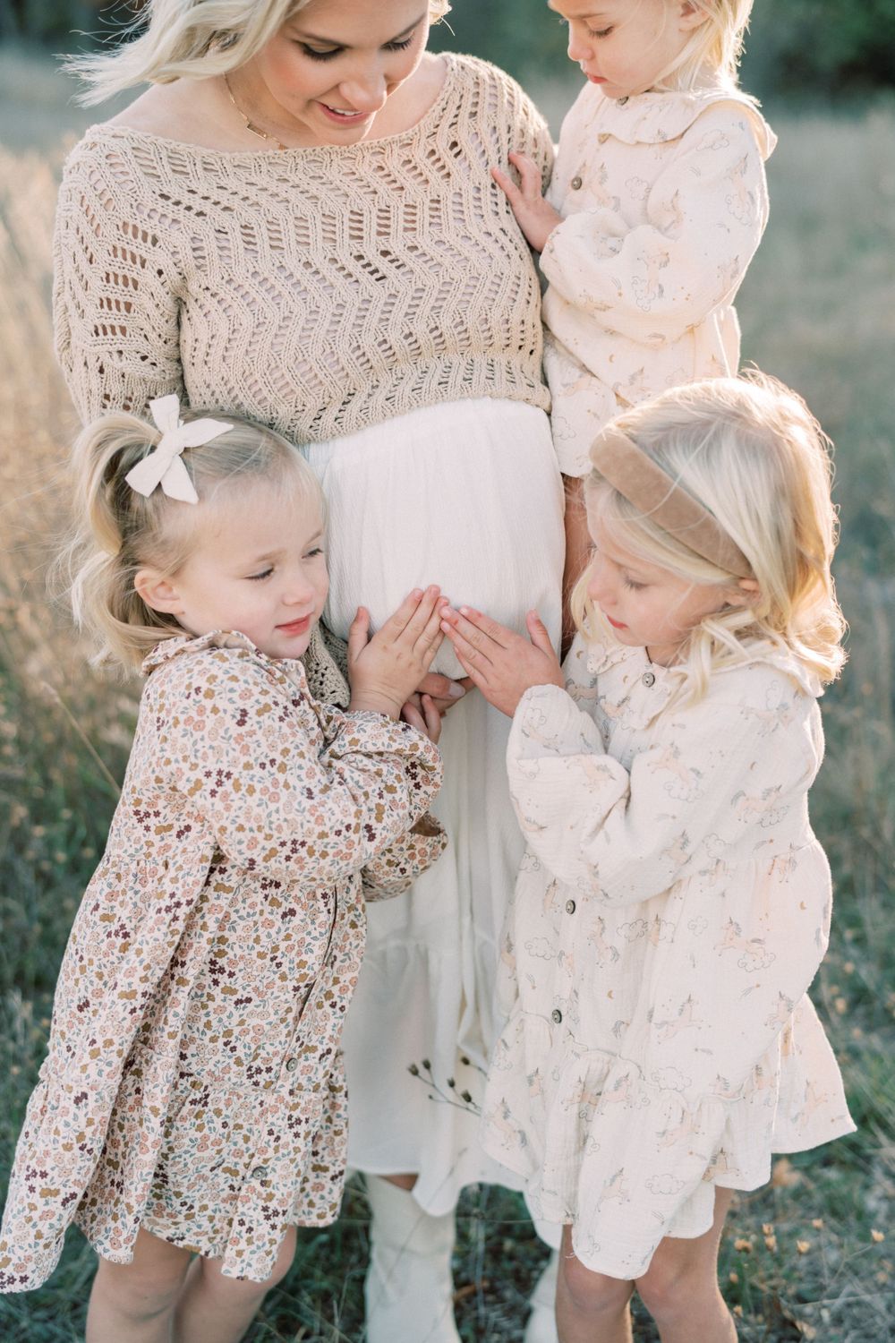 Sweet moment with family in coordinating outfits gathered in autumn field.