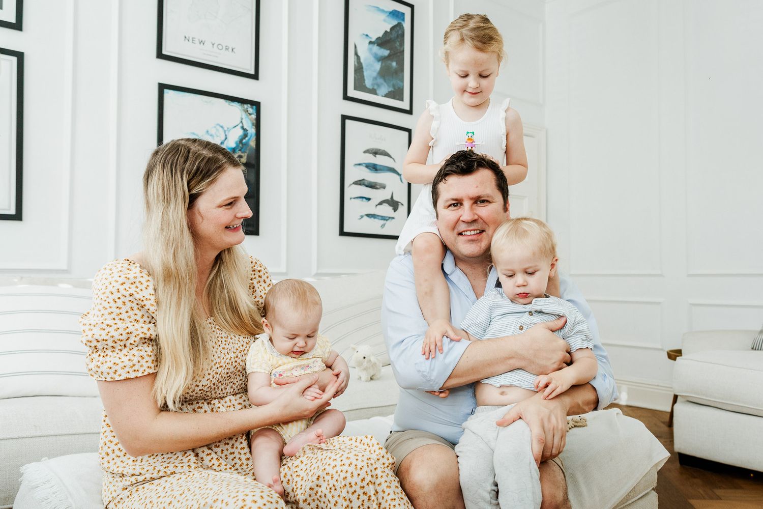 A family of five smile and look relaxed during their at home photoshoot. Bristol family photos by Little Bodhi Photography