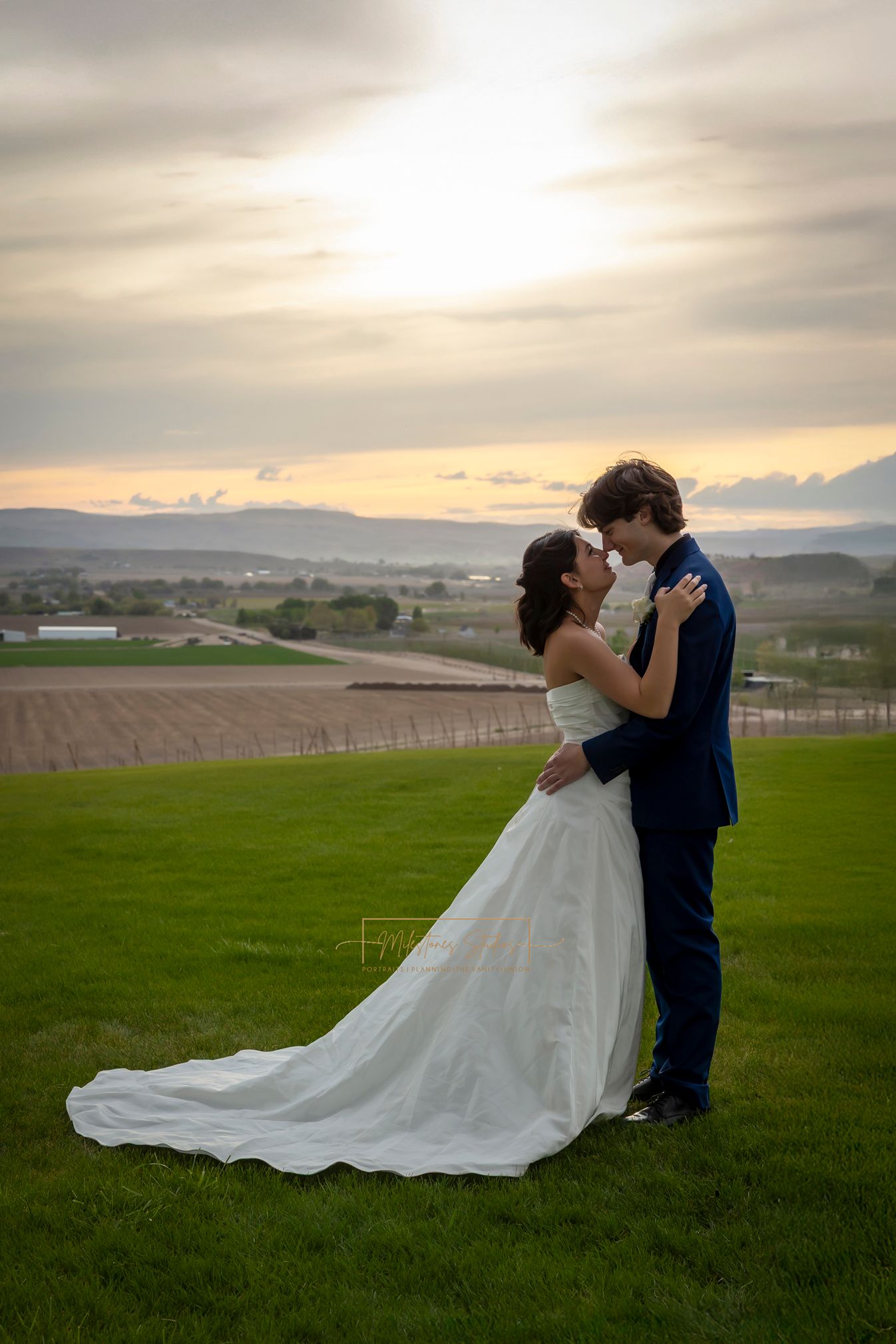 Bride and groom embracing, looking at each other at sunset, Garman Hill