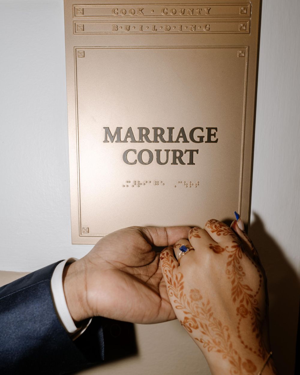 Two hands meet while holding a paper labeled Marriage Court, symbolizing a civil wedding ceremony.