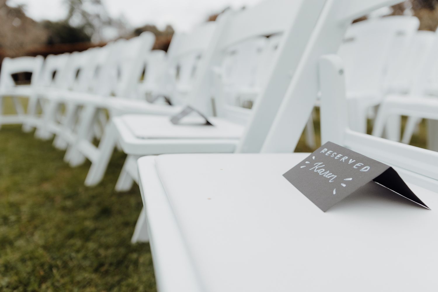 Wedding ceremony chair with a reserved sign in black and white.