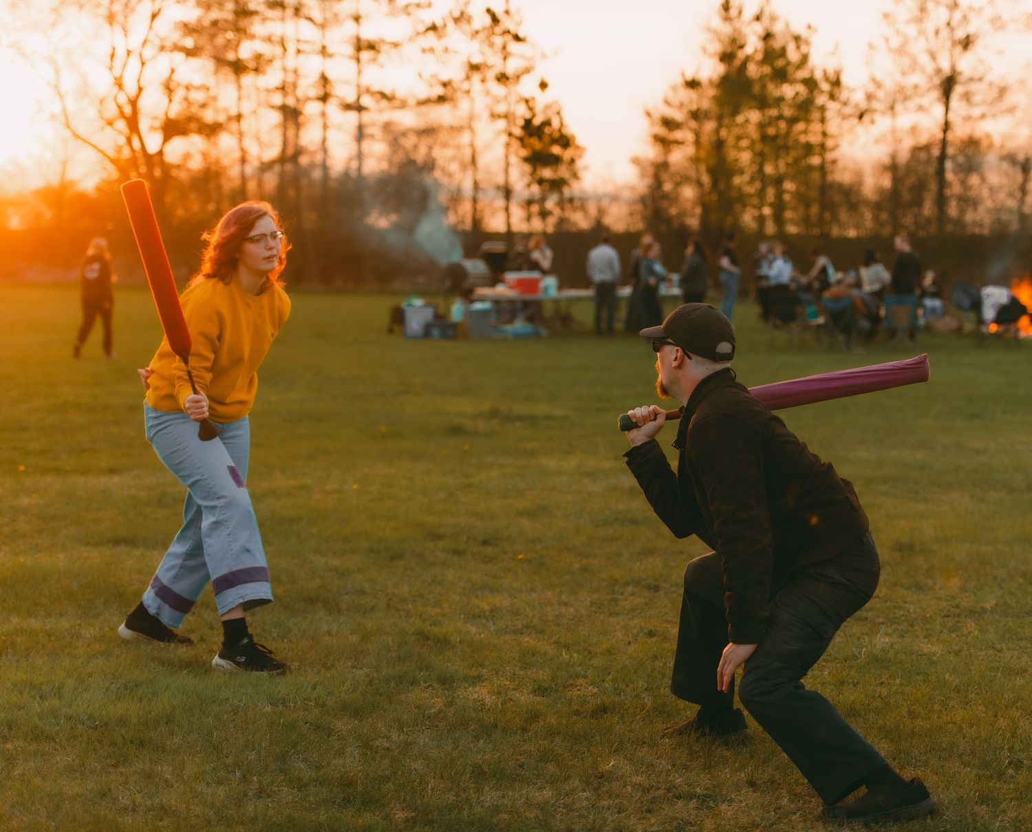 Play sword fighting in tunics around a bonfire at sunset