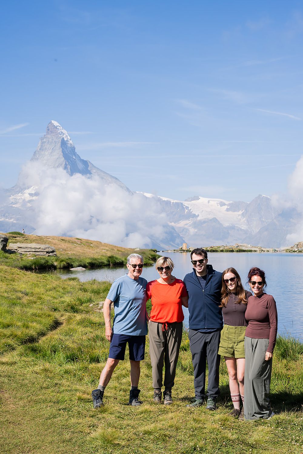 Surprise proposal in Zermatt by an alpine lake with Matterhorn view, emotional moments and family celebration in the Swiss Alps.