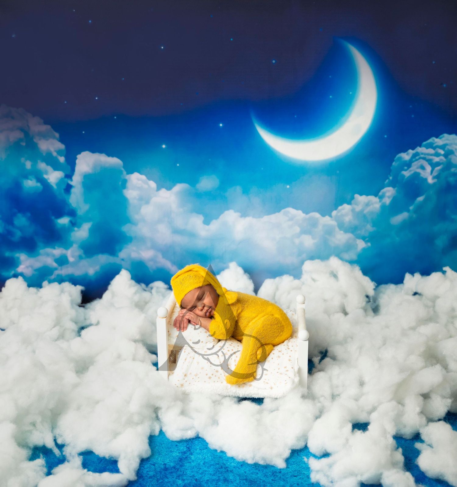 Dreamy night sky scene with crescent moon and fluffy white clouds against deep blue background.