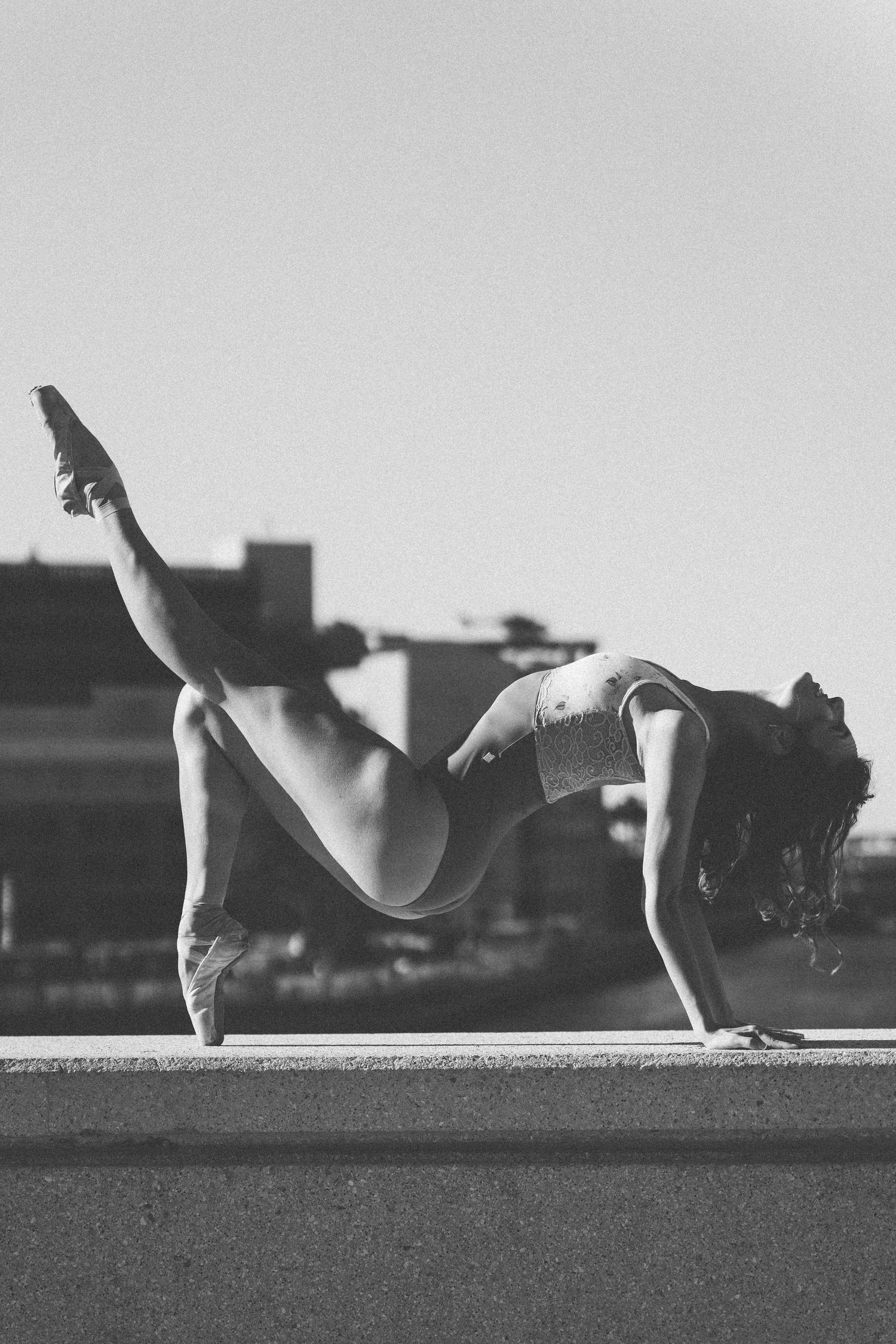 Tampa Dance Photography Black and White image of a ballerina on a ledge