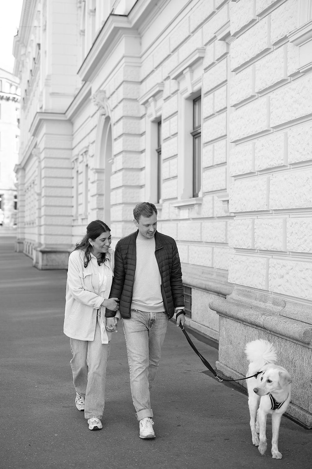 Modern young couple's simple engagement photo session with their fluffy dog in the city of Zurich, stylish and full of joy