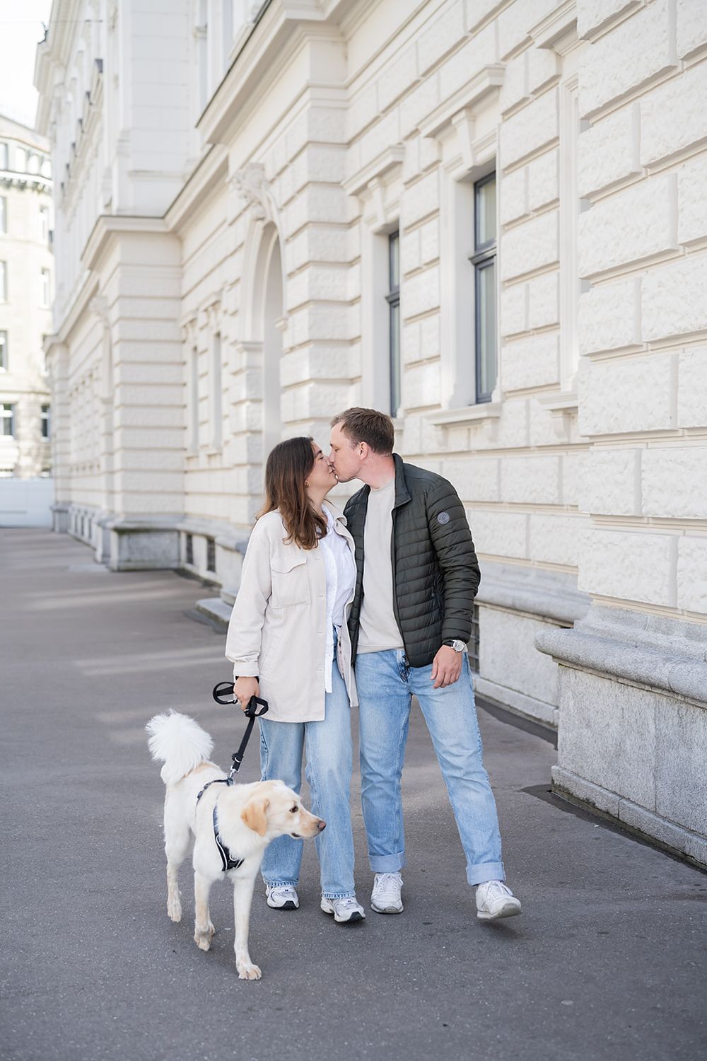 Modern young couple's simple engagement photo session with their fluffy dog in the city of Zurich, stylish and full of joy