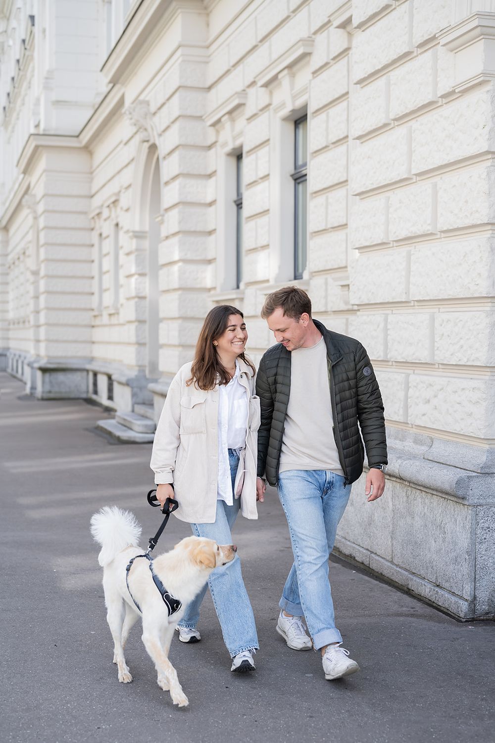 Modern young couple's simple engagement photo session with their fluffy dog in the city of Zurich, stylish and full of joy