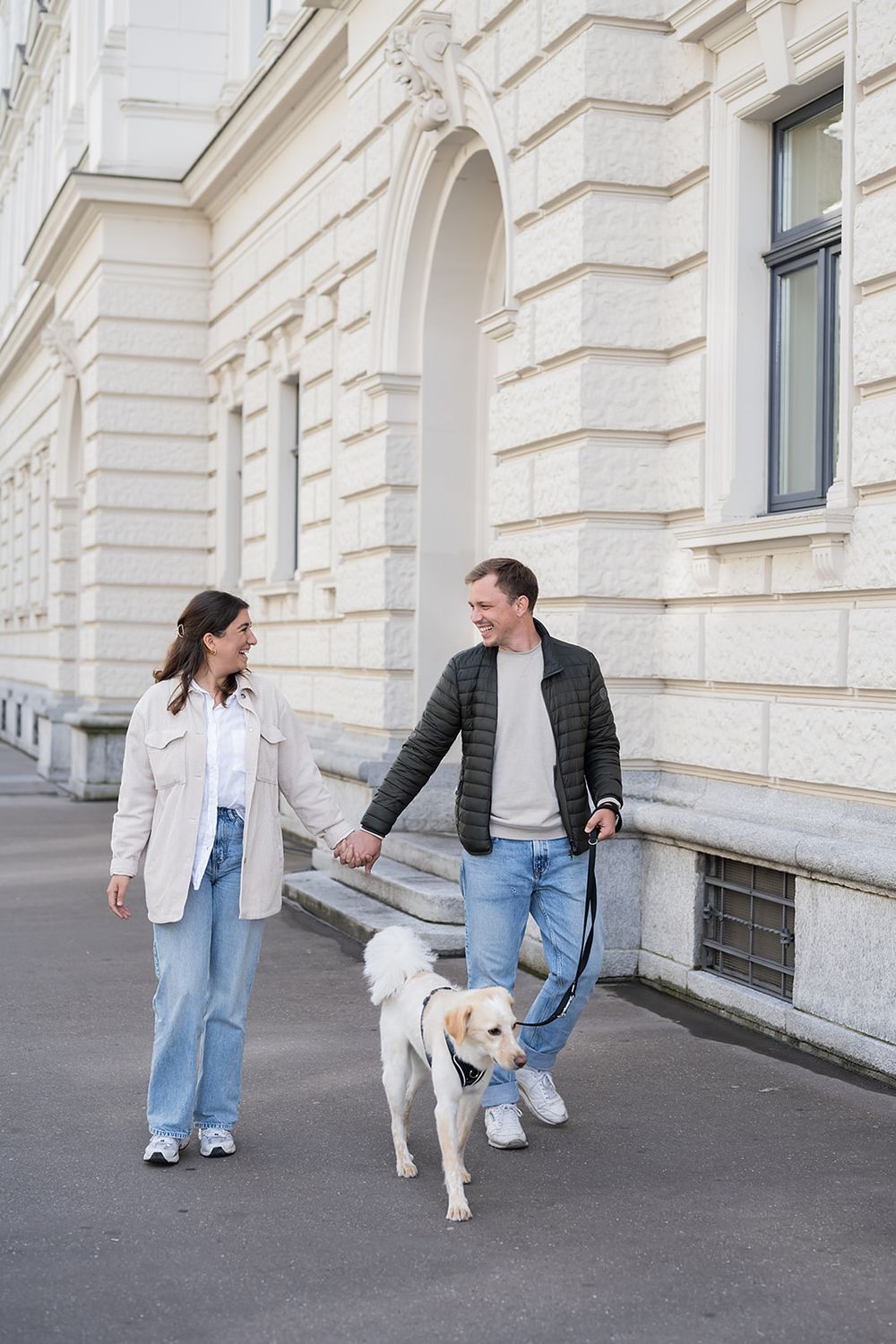 Modern young couple's simple engagement photo session with their fluffy dog in the city of Zurich, stylish and full of joy