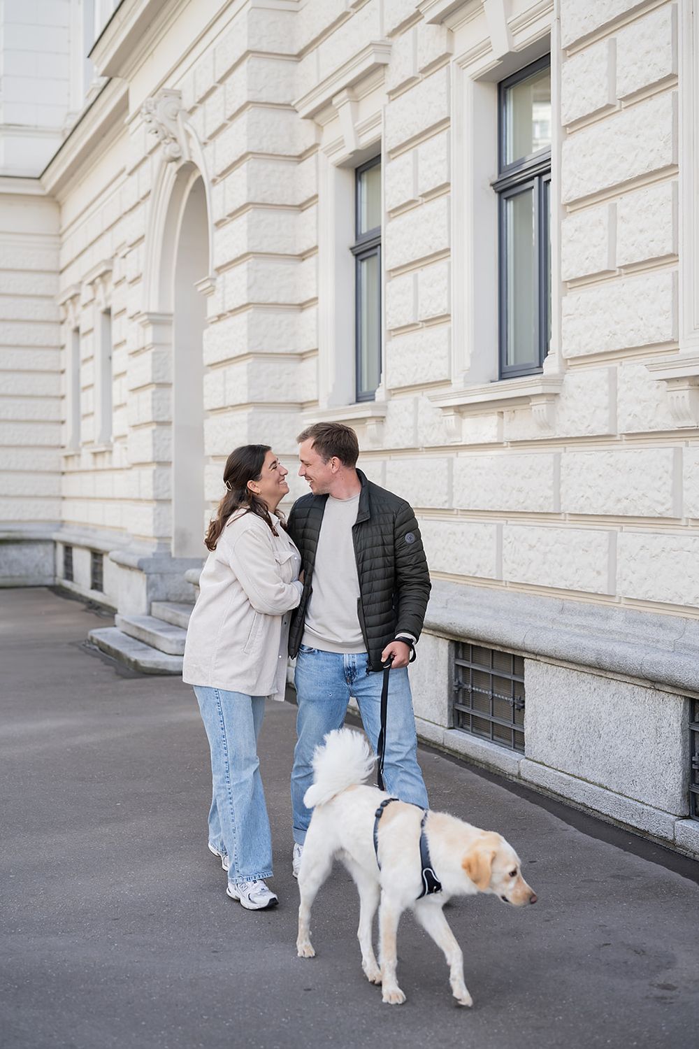 Modern young couple's simple engagement photo session with their fluffy dog in the city of Zurich, stylish and full of joy