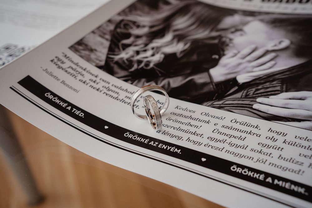 A black and white newspaper or magazine page showing text and photography with a circular seal or stamp overlay.