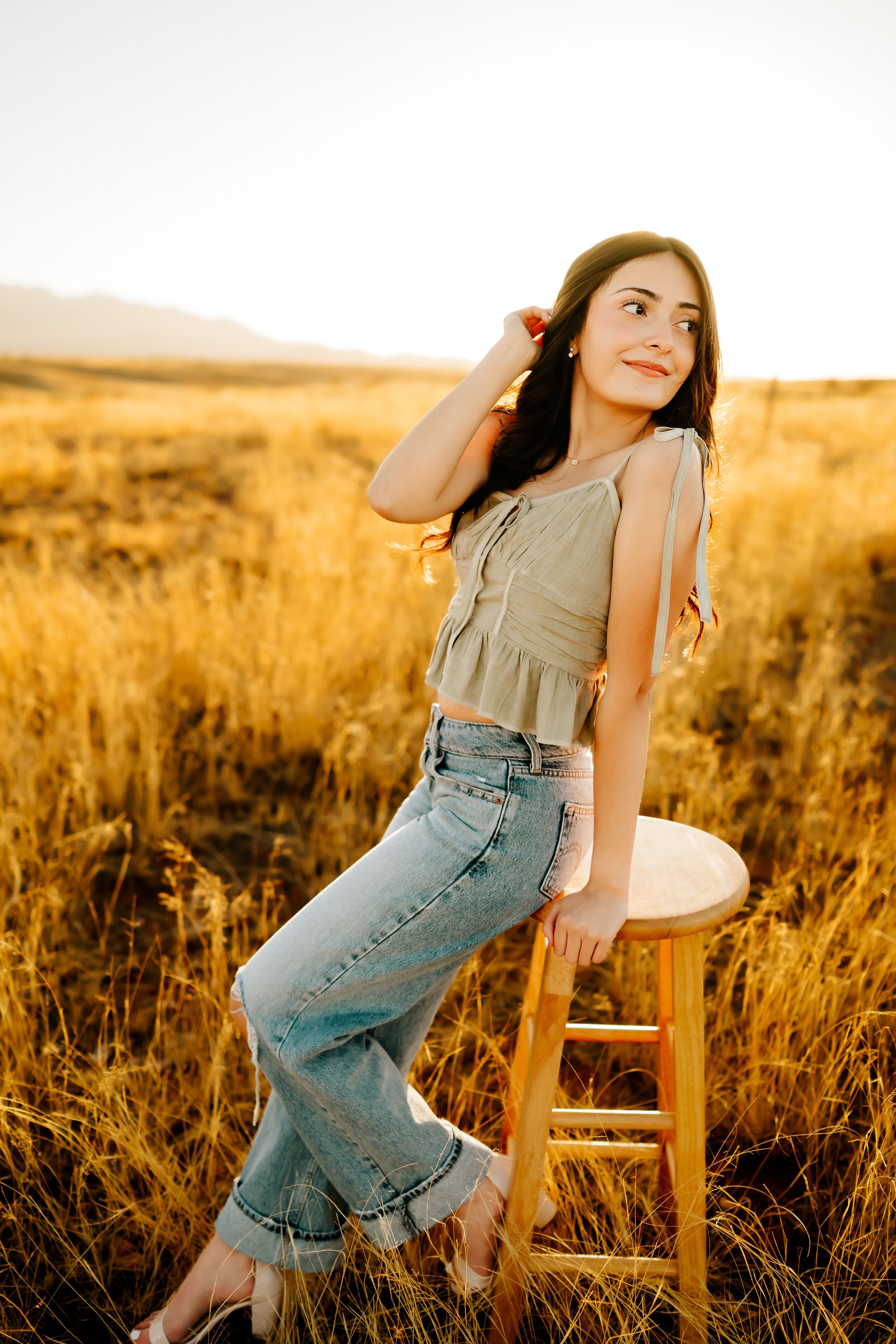 Stunning senior girl in golden hour grassland backdrop near Tucson AZ_01