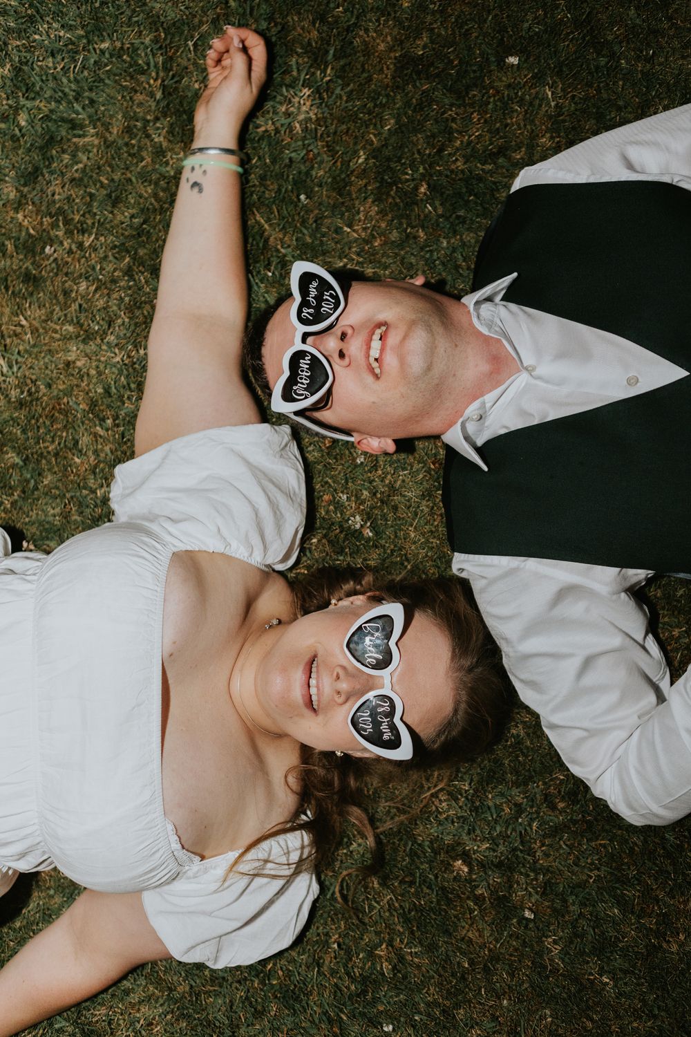 Person in white shirt and heart-shaped sunglasses lying on ground in multiple perspectives.