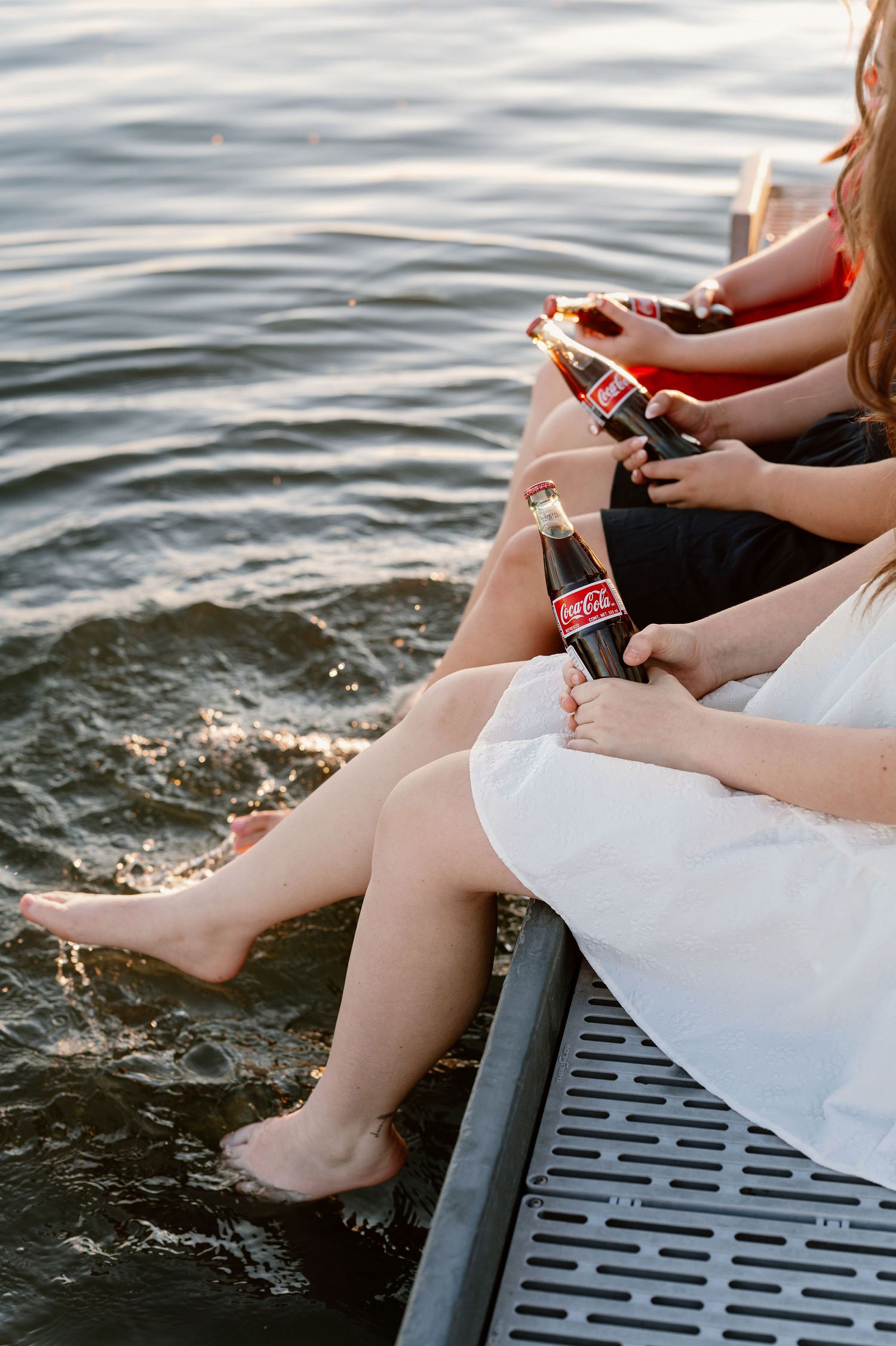 Patriotic senior pictures on a dock with vintage Coke bottles