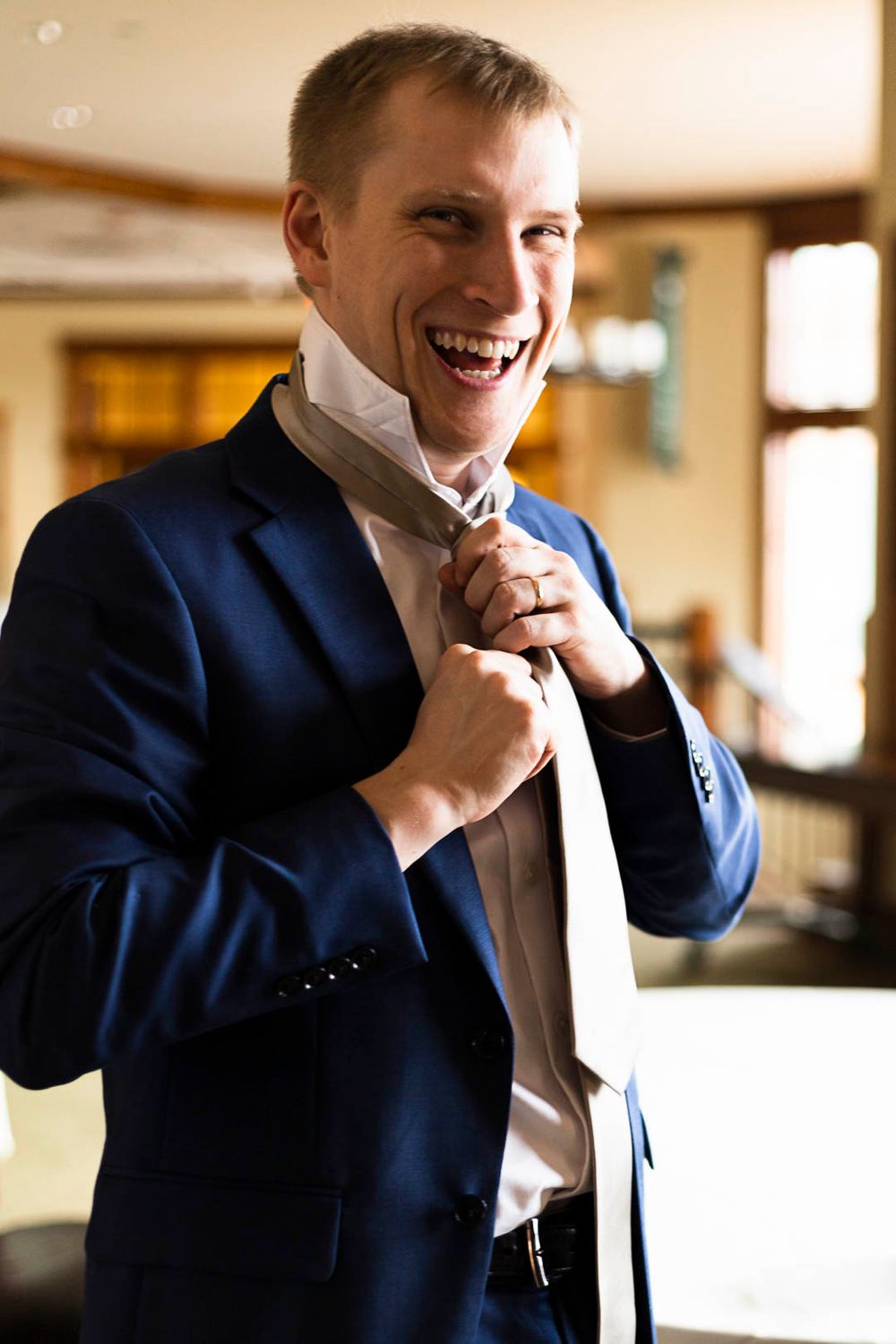 A formal portrait in a navy suit preparing for a special occasion.