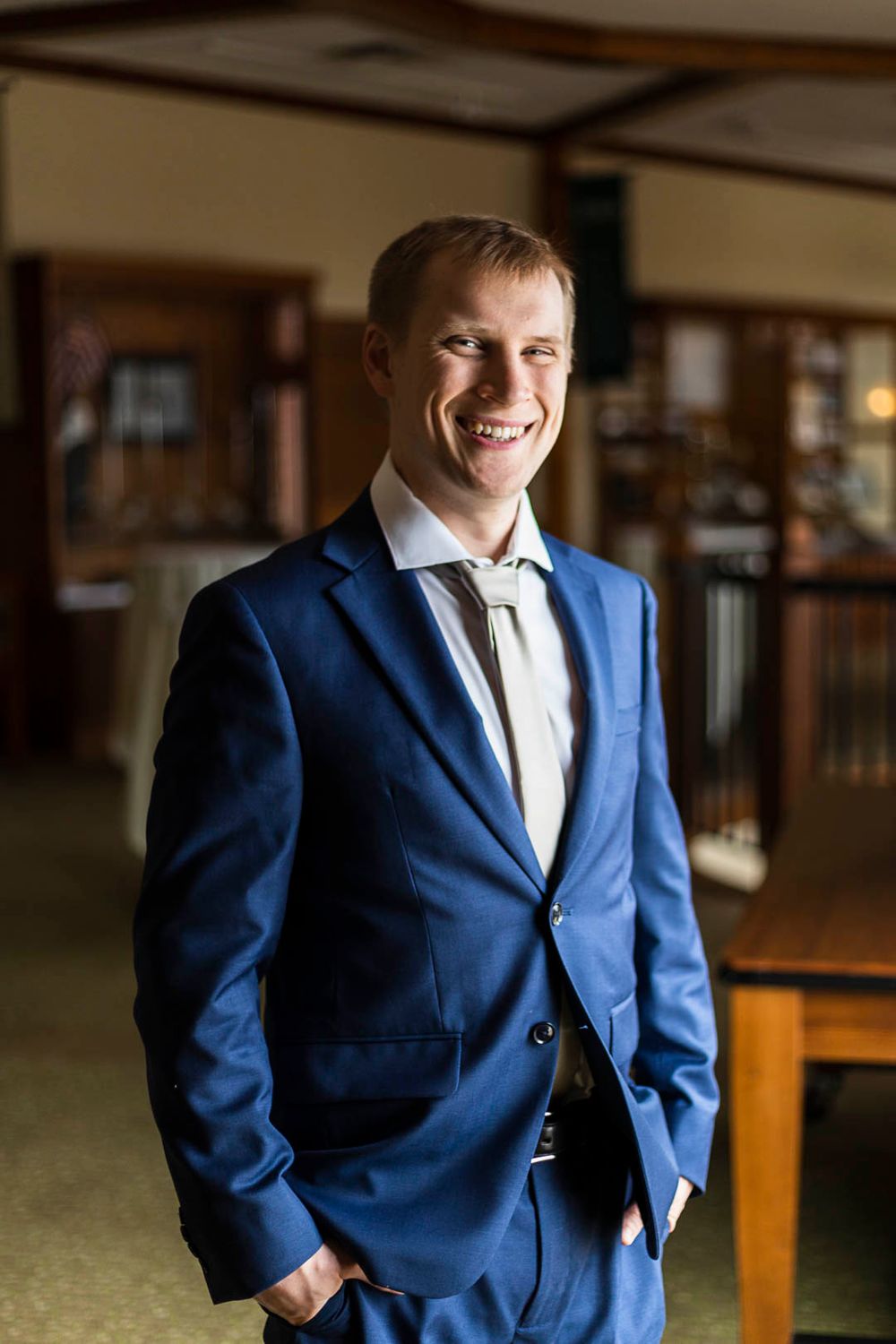 A polished look in a fitted navy blue suit standing confidently.