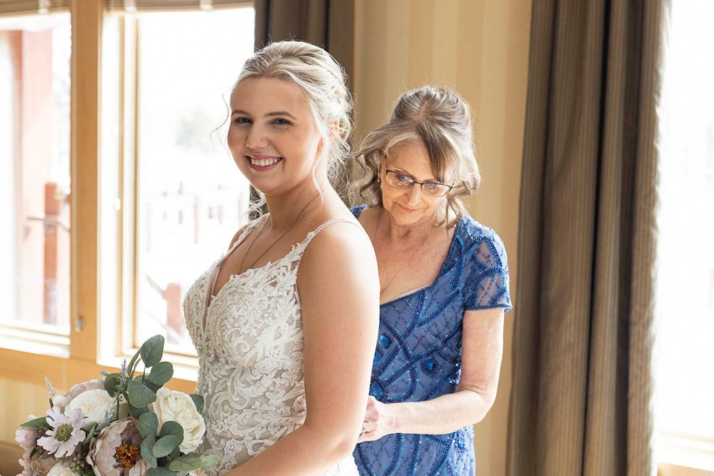 Sweet getting ready moment in natural window light.