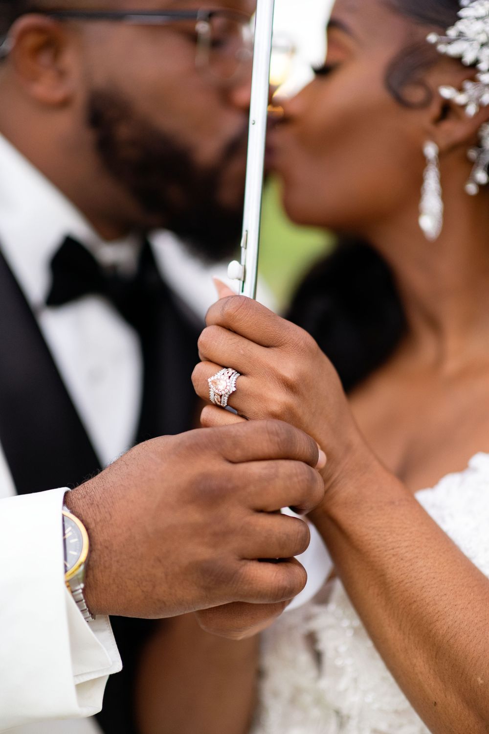Close-up series showing a couple's hands wearing elegant wedding rings during a romantic moment at their ceremony.