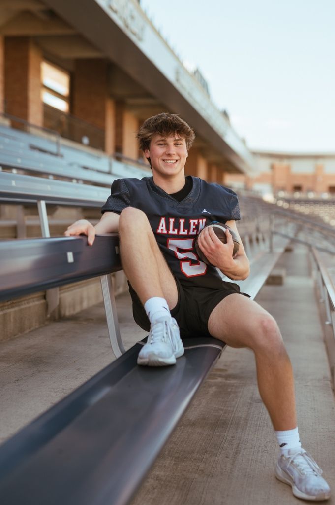 Student athlete in Allen jersey rests on stadium bleachers during a photoshoot.