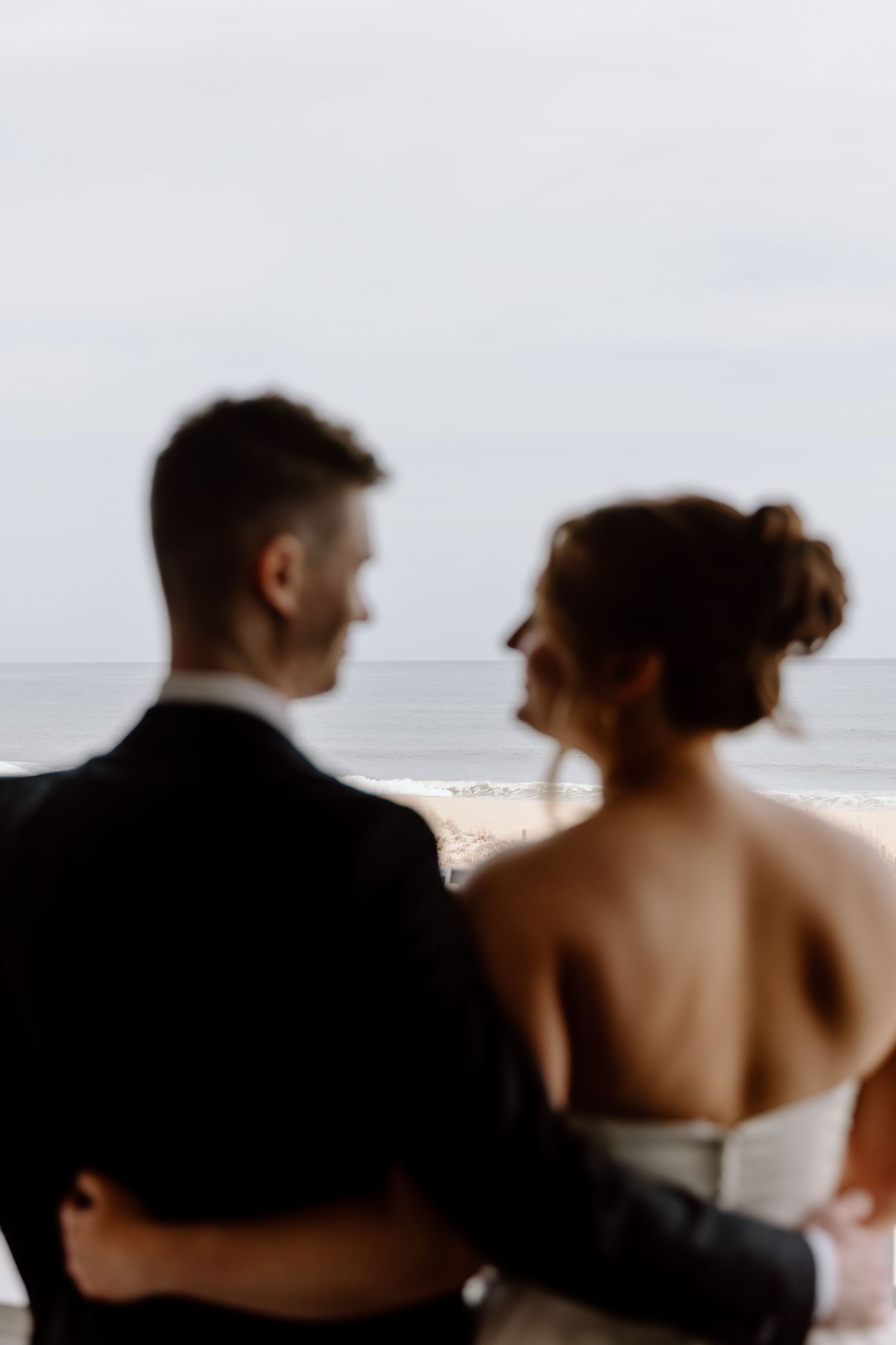 A progression of five frames shows a couple at the beach, sitting side by side and gradually becoming more blurred.