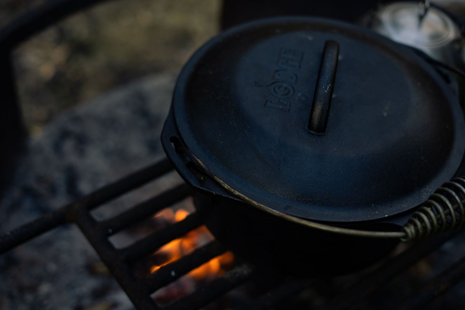 Lodge Dutch oven over an open fire, perfect for outdoor cooking and campfire meals.