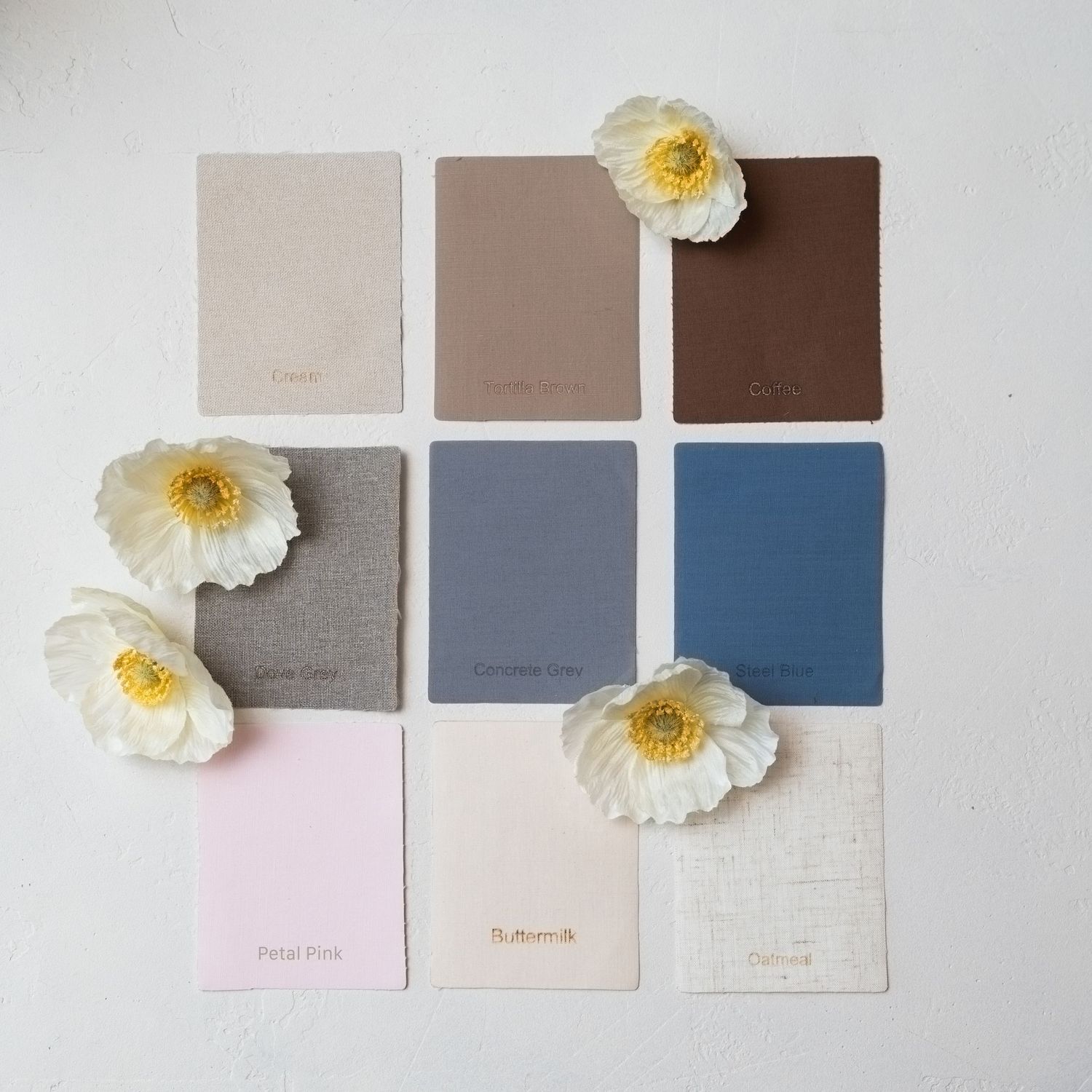 Interior design color palette featuring neutral tones and white flowers arranged in grid pattern.