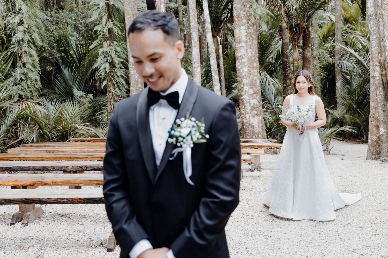First look wedding photo at a tropical garden venue captured by Apertured Media Auckland Wedding Photographer.