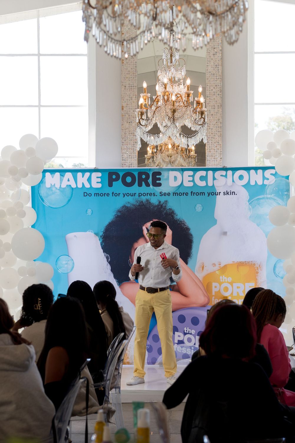 Corporate presentation with projection screen showing skincare marketing campaign.