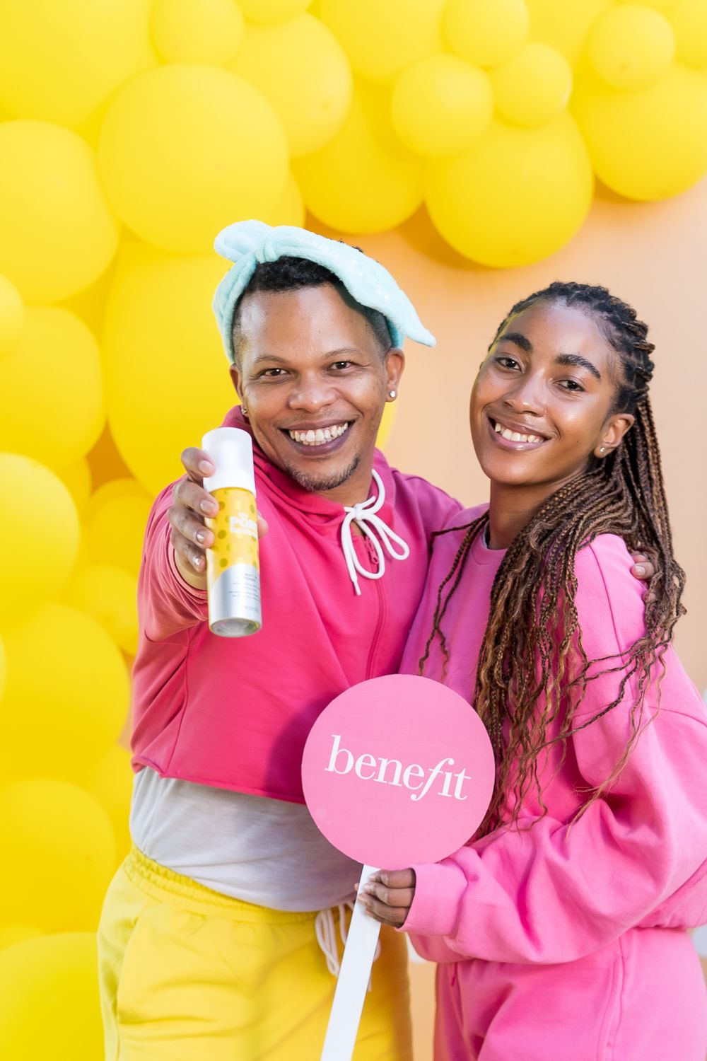 Yellow balloon wall backdrop provides vibrant setting for product photography.