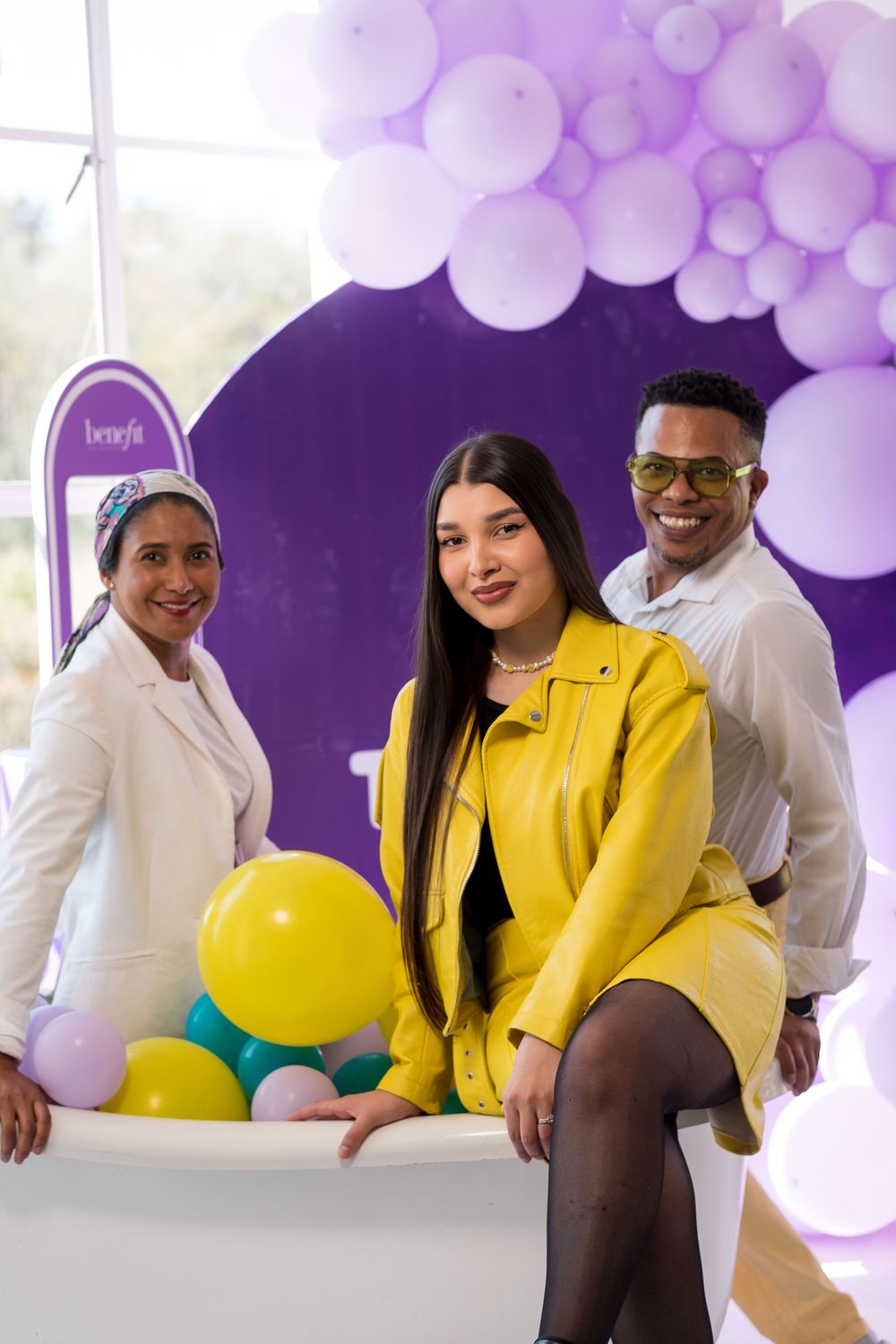 Purple and white balloon decorations create festive atmosphere at corporate event.
