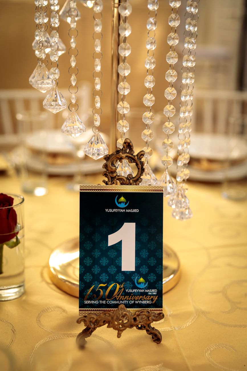 Elegant table setting with hanging crystal decorations and table number one card.