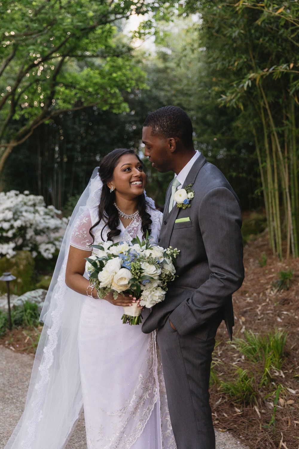 A joyful couple share an intimate moment in a lush garden setting at a colorado hotel elopement