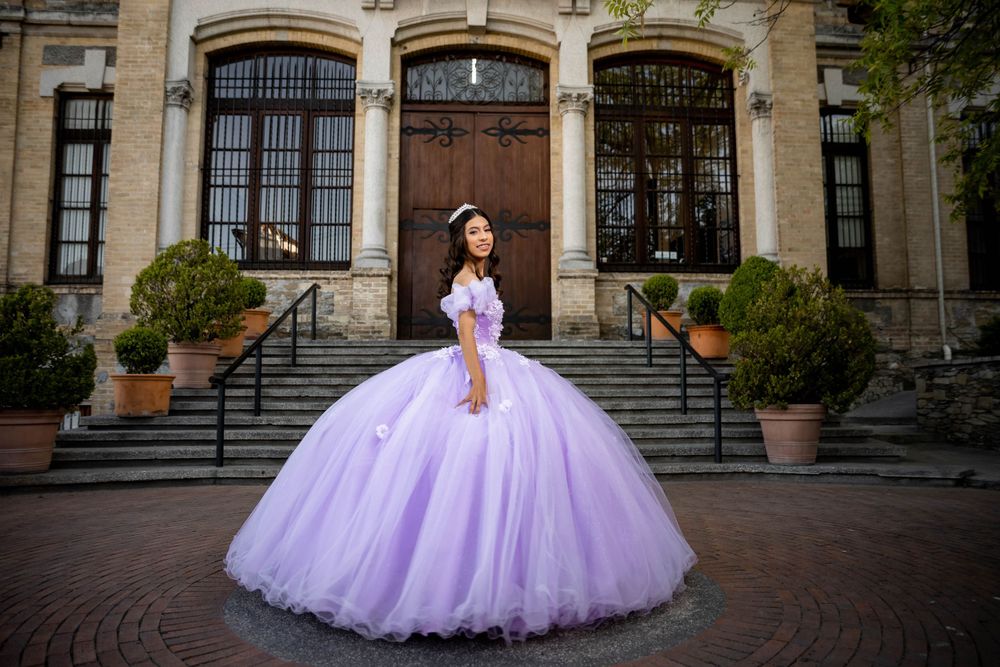 Majestic lavender ballgown photographed on grand building steps with classical architecture.