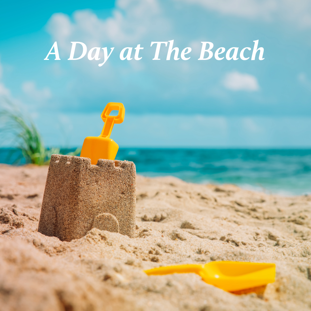 A yellow toy shovel and sandcastle on a tropical beach with turquoise ocean water and palm trees in the background.