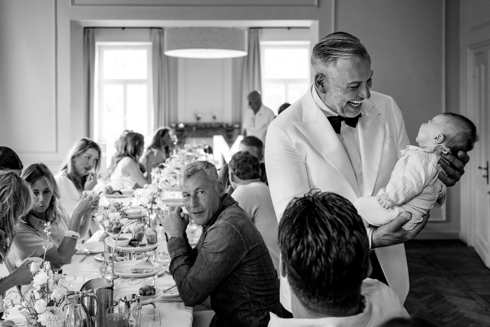 Black and white candid moments captured during an intimate wedding reception dinner.