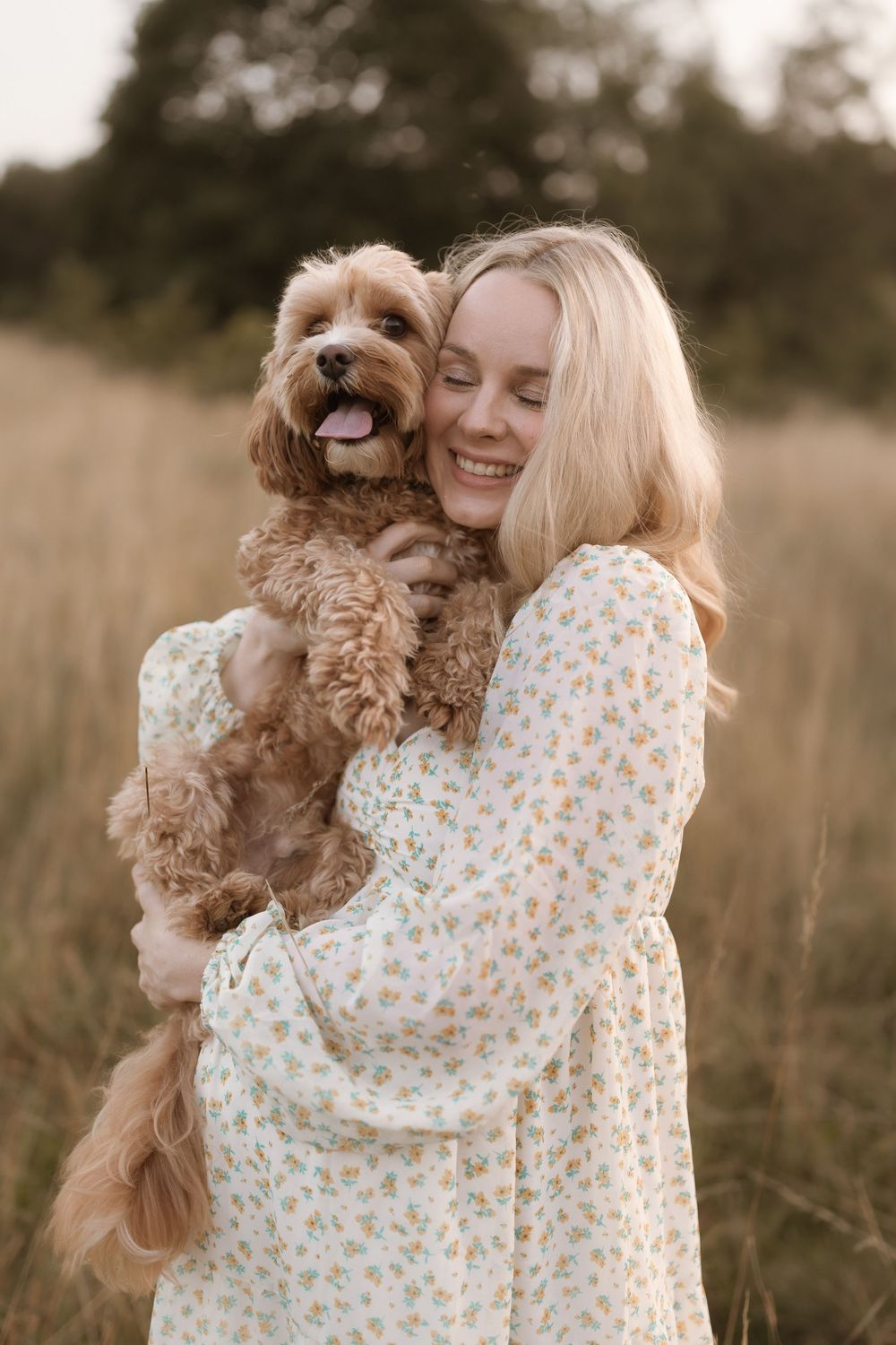 A heartwarming sequence shows someone in a floral dress hugging and playing with a fluffy brown Goldendoodle dog in a field.