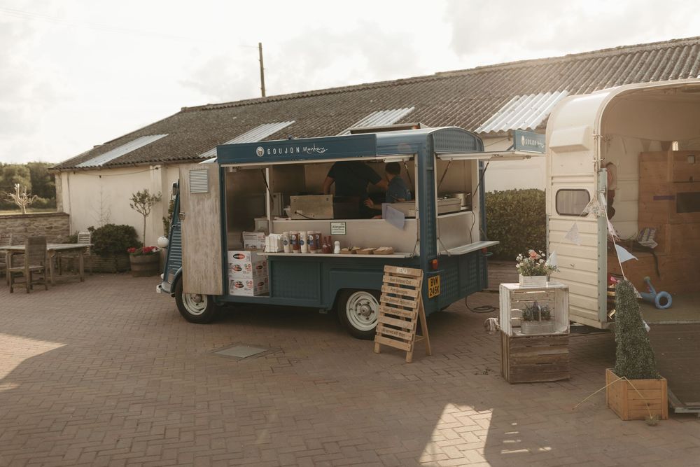 Vintage-style food truck parked on brick pavement at outdoor event.