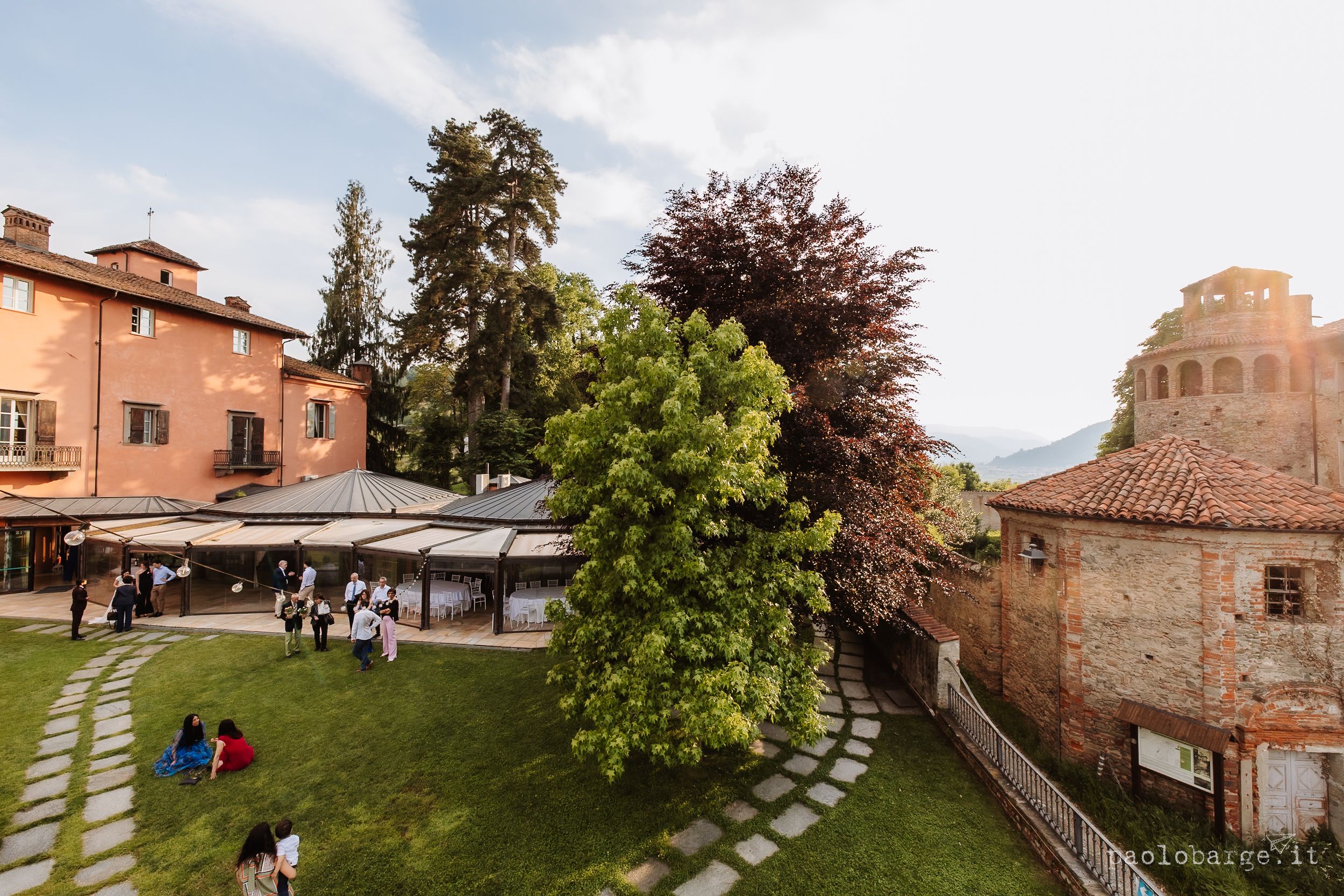 Outdoor garden terrace with stone pathway and Mediterranean architecture at a rustic Italian villa resort.