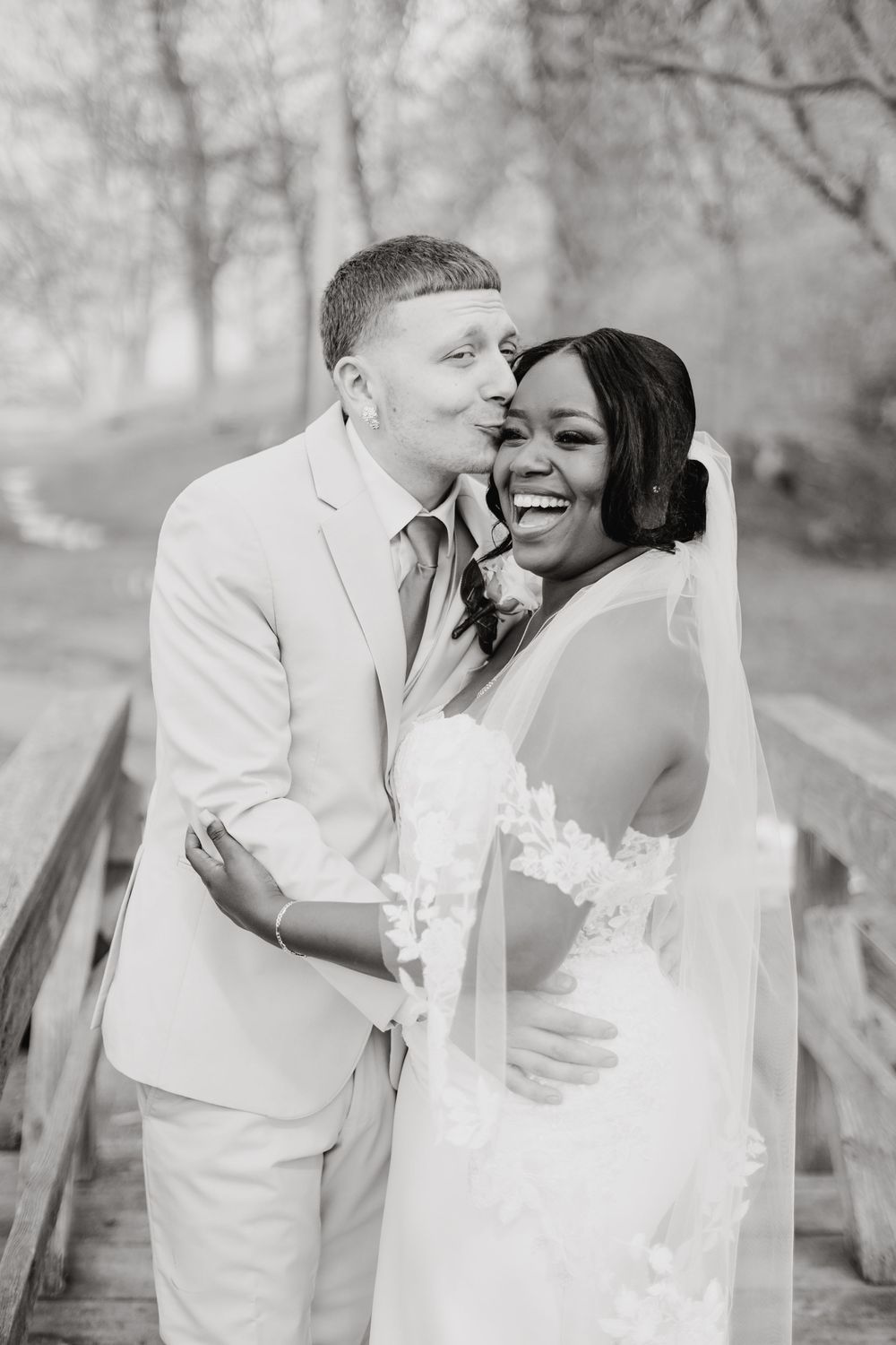 A romantic black and white photo series of a couple in wedding attire sharing intimate moments outdoors.