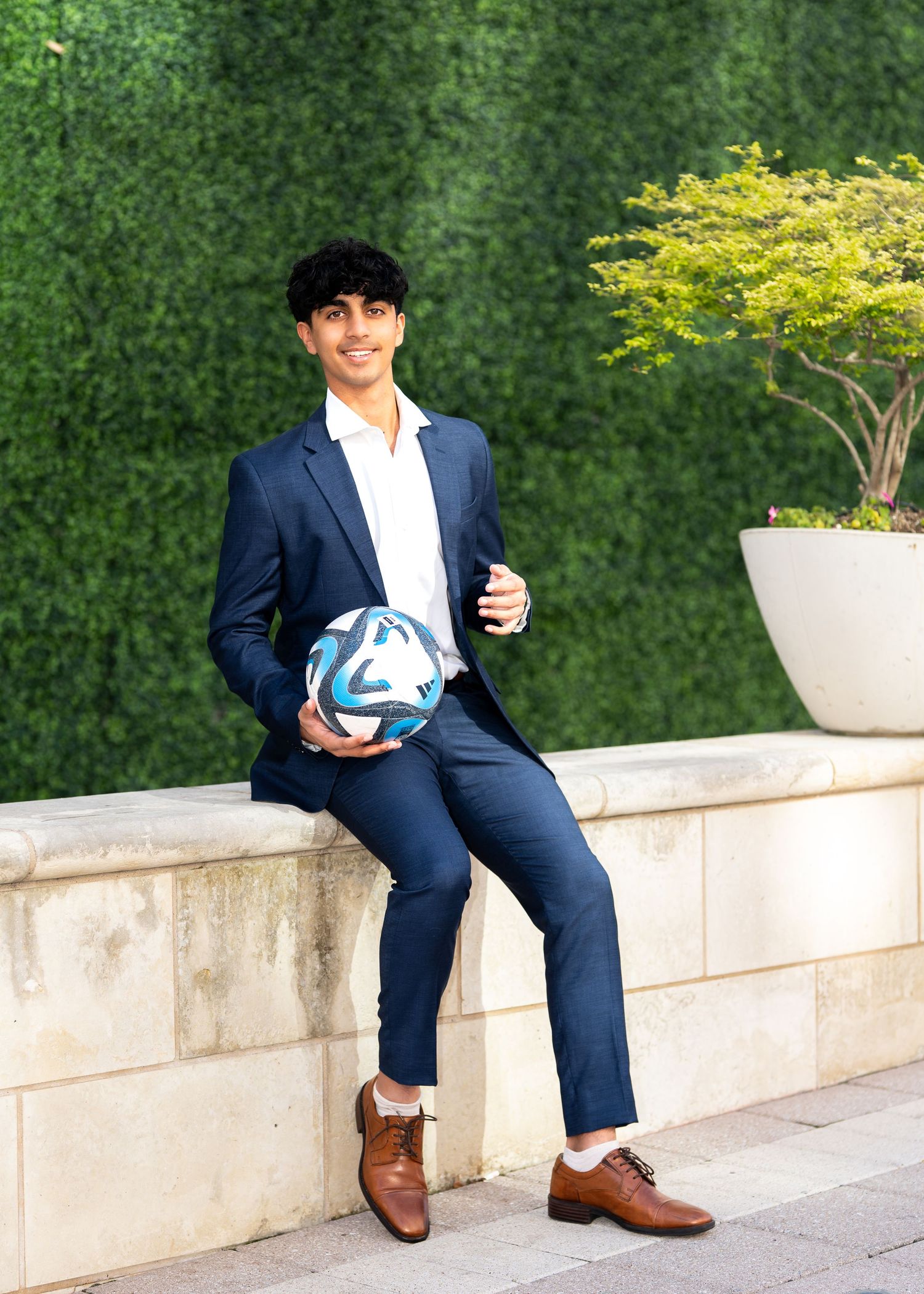Guy senior photo session Legacy West Plano Texas with soccer ball