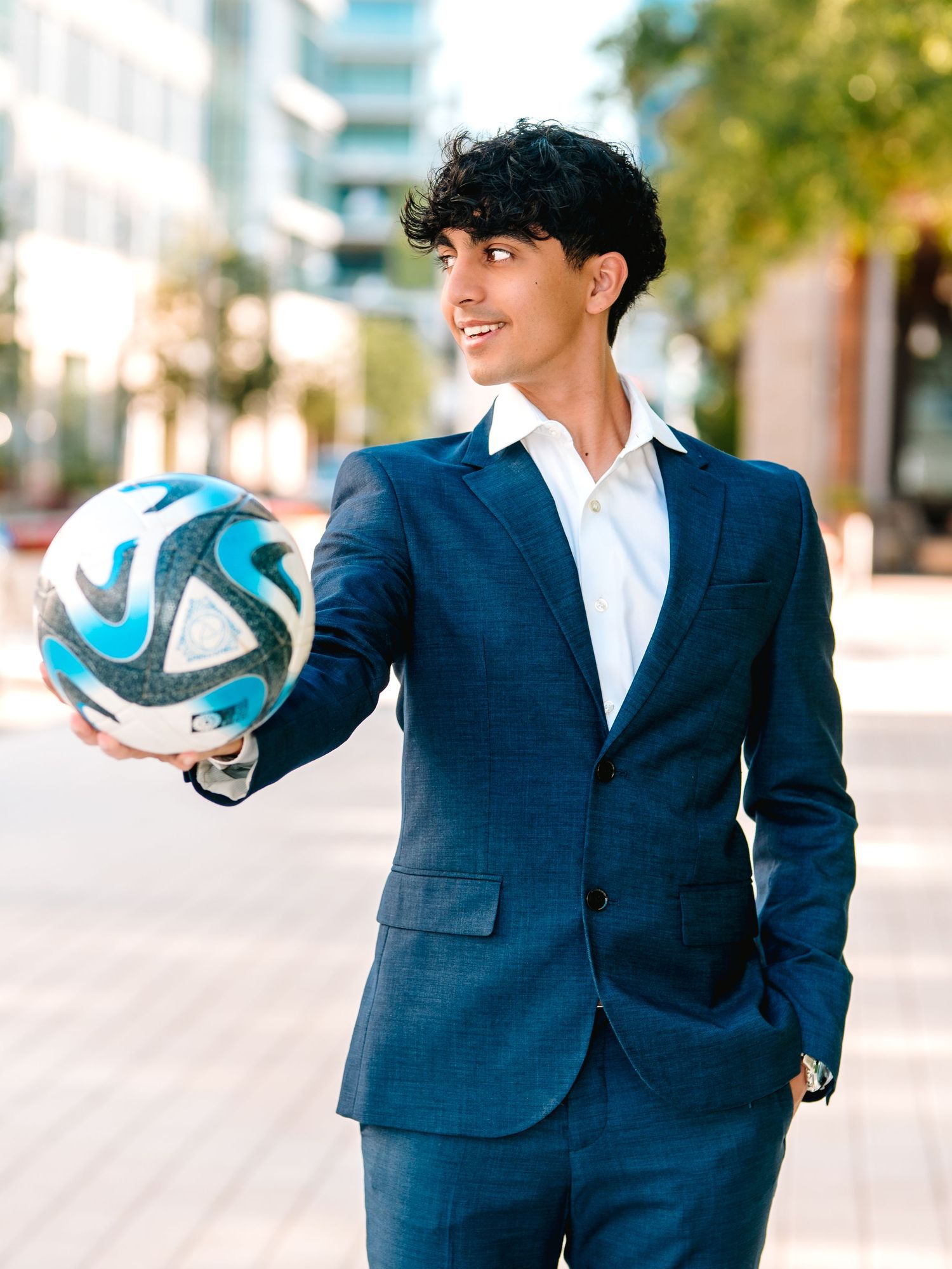 Guy senior photo session Legacy West Plano Texas with soccer ball