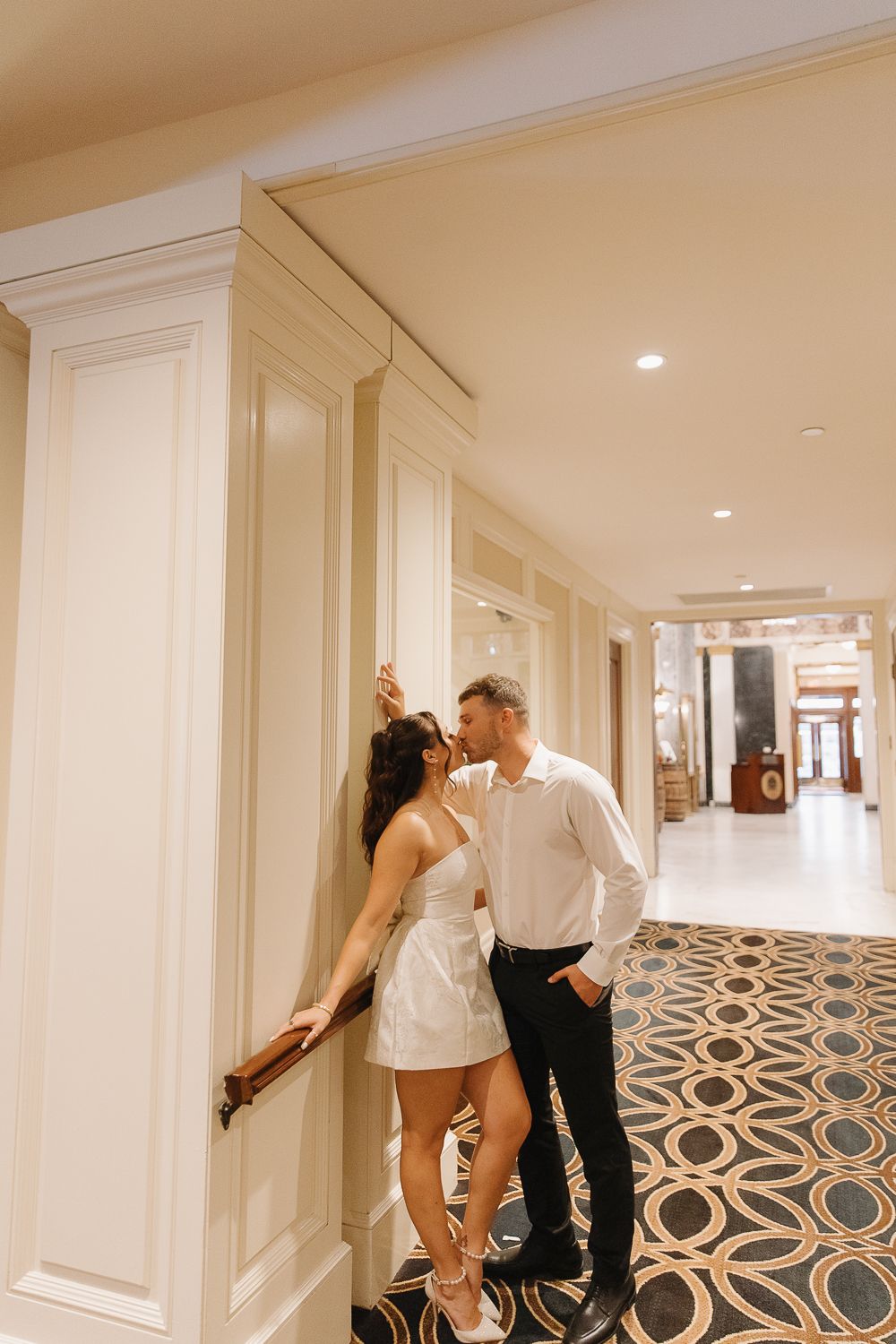 Intimate wedding photo in elegant hotel hallway with geometric patterned floor at the Seelbach Hotel in Louisville, Kentucky.