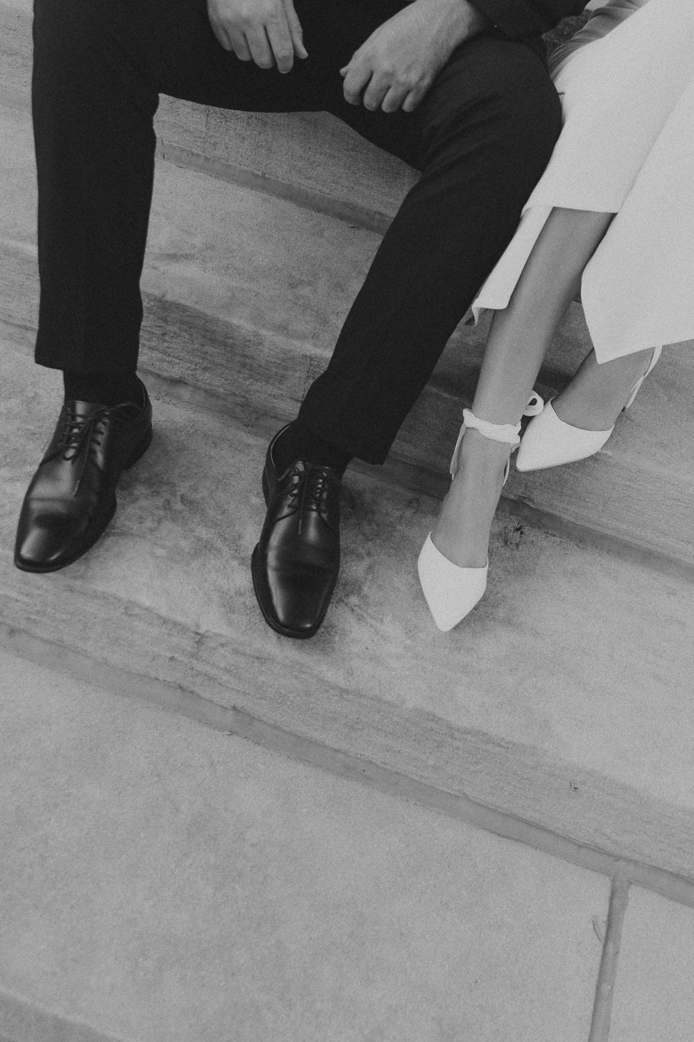 Black and white detail shot of formal shoes on stone steps in Louisville, Kentucky.