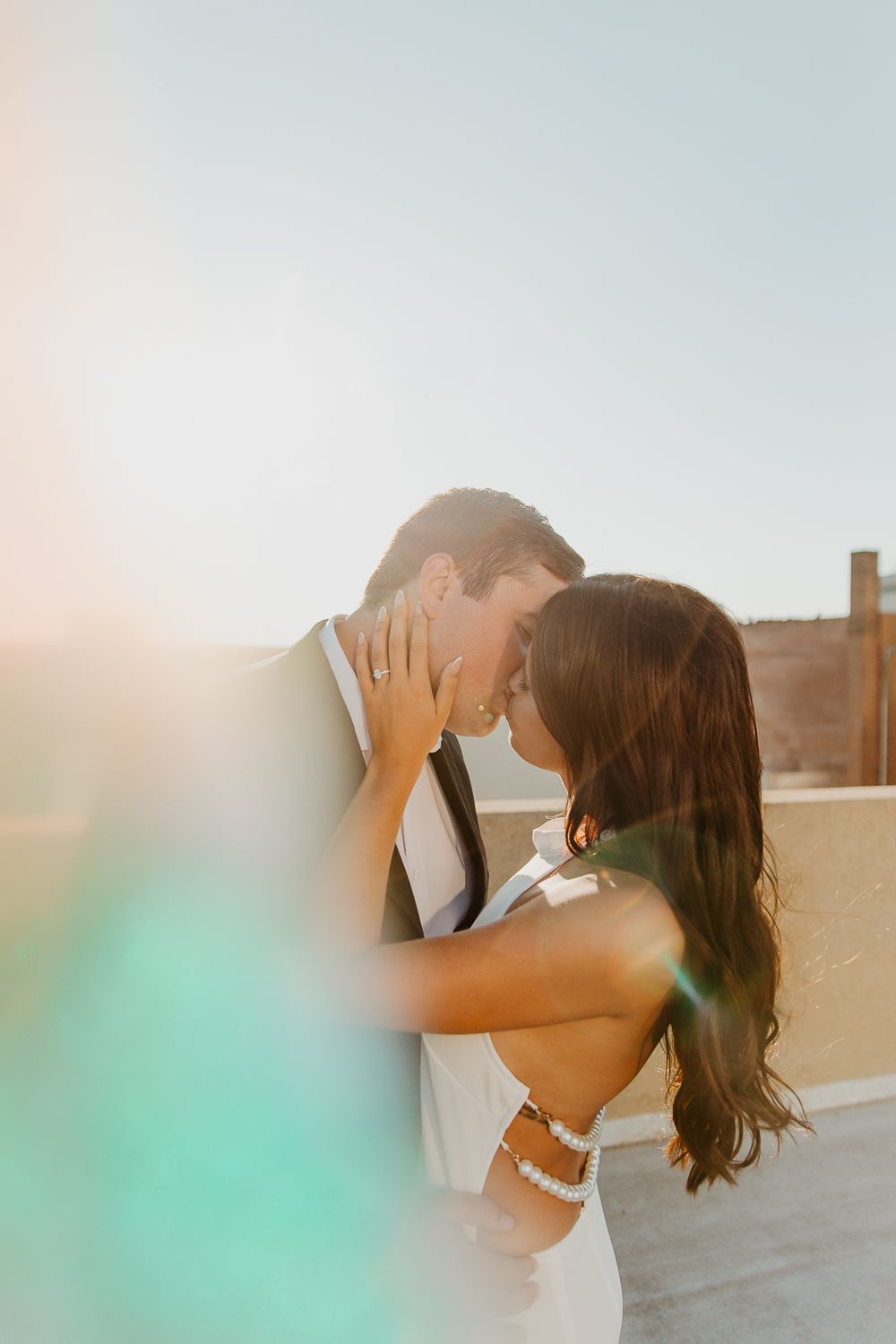 Romantic sunset portrait of a couple embracing on a rooftop in Louisville, Kentucky.