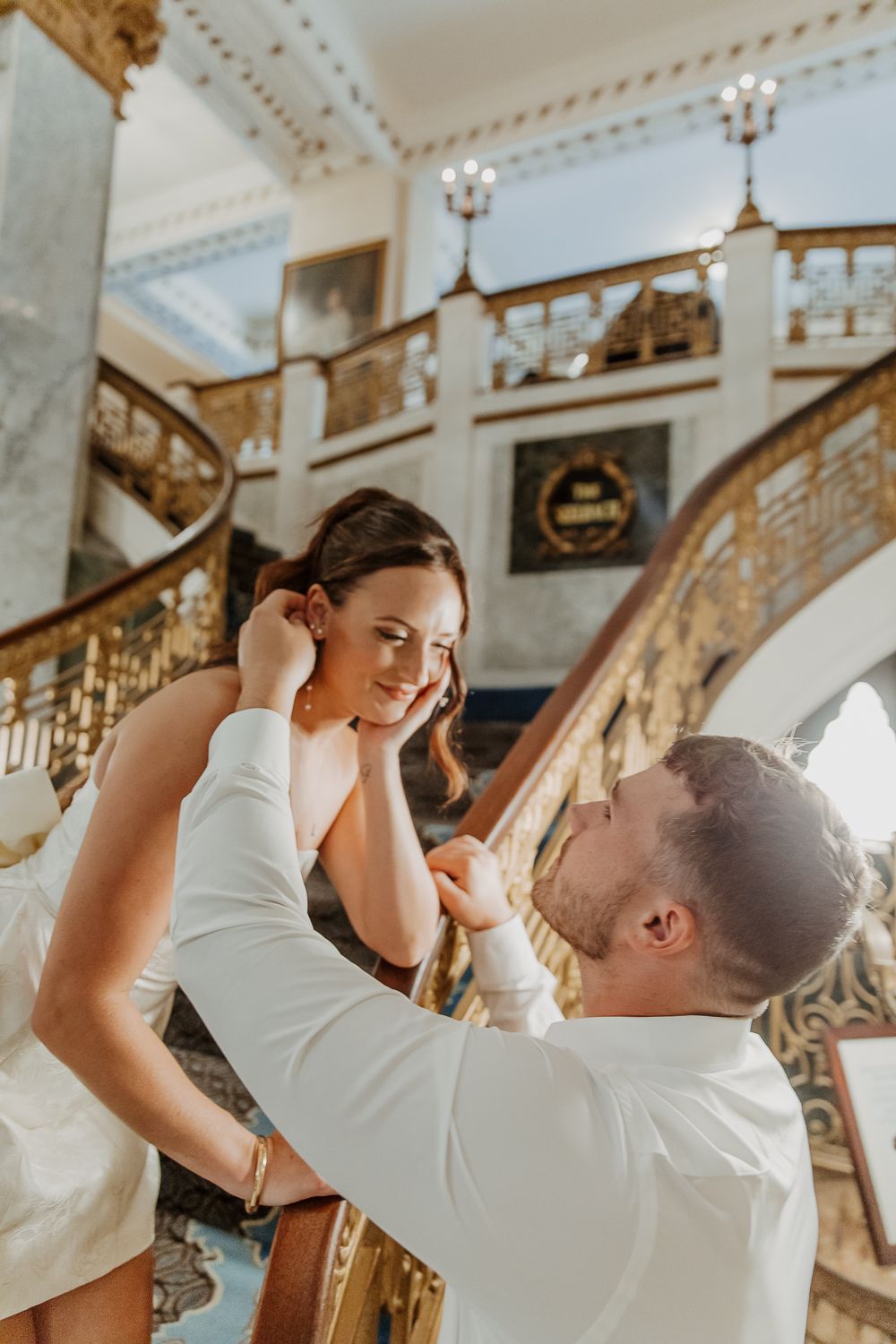 Romantic moment captured on an ornate vintage staircase with elegant architecture in Louisville, Kentucky.