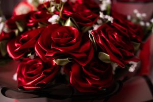 Close-up of deep red artificial roses arranged in an elegant bouquet.