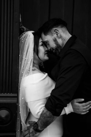An intimate black and white portrait of a couple on their wedding day.