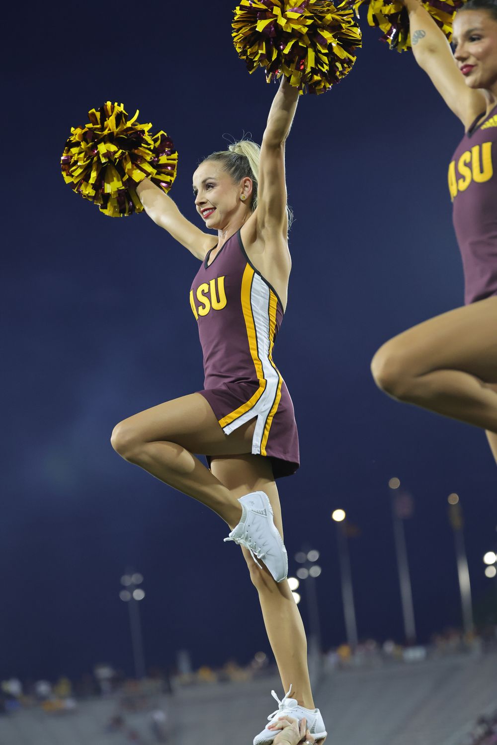 An ASU female college student, as part of the dance team, hits a dramatic pose in Tempe, Arizona