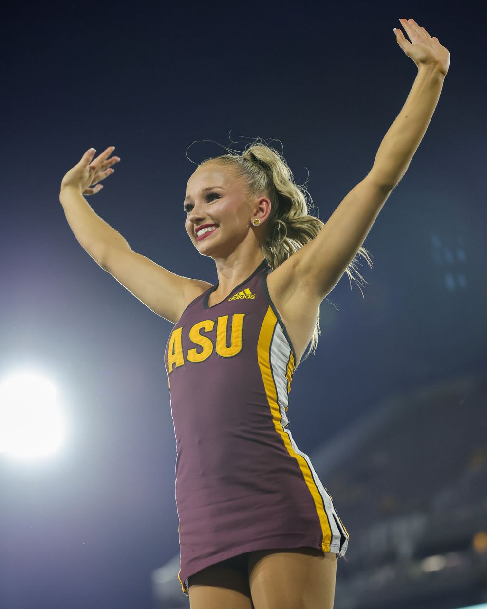 An ASU female college student, as part of the dance team, hits a dramatic pose in Tempe, Arizona