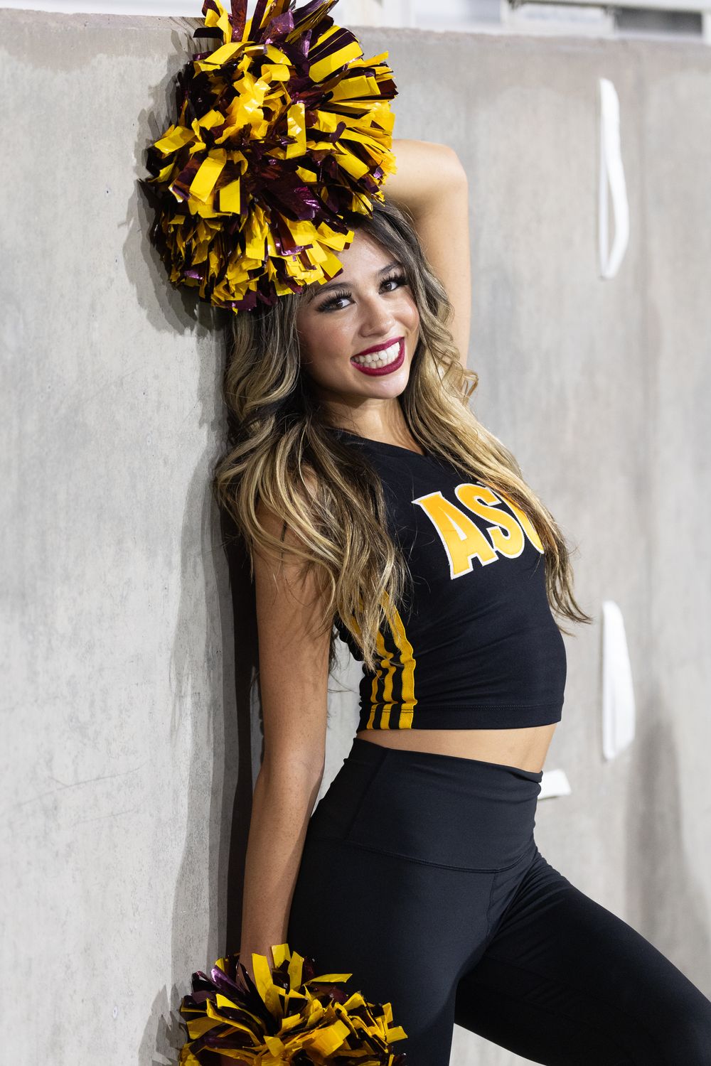 An ASU female college student, as part of the dance team, hits a dramatic pose in Tempe, Arizona